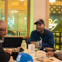 Four gentlemen sitting together at event